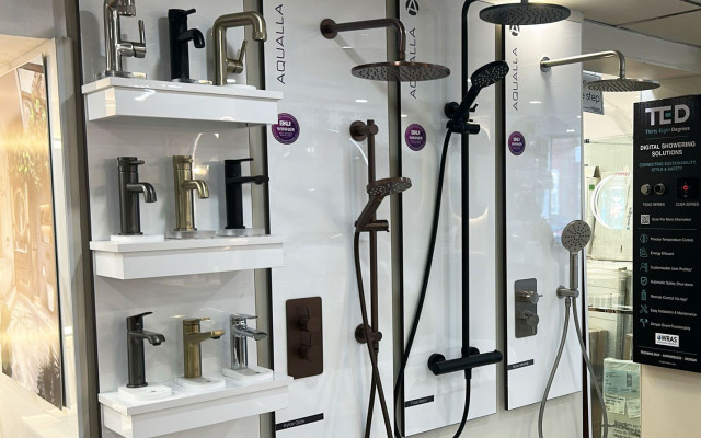 A range of Aqualla bathroom fittings showcased in a chic display.