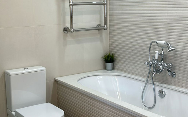 Elegant cream bathroom display featuring a luxurious tub and modern fixtures.