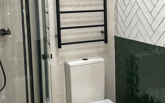 Stylish Small Bathroom Display with Black Radiator and Modern Fixtures